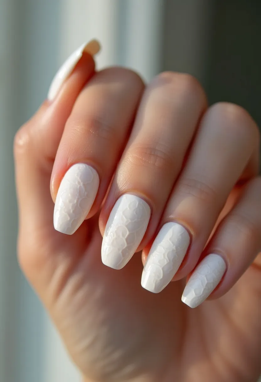 The nail design features a monochromatic white color palette, giving the nails a clean and elegant look. The nails are medium-length and shaped almond with a slightly pointed tip, providing a stylish and feminine appearance. Each nail showcases an intricate embossed pattern that resembles a delicate lace or floral motif, adding texture and sophistication to the overall design. The nails appear to be treated with gel, which provides a glossy and durable finish, ensuring the intricate patterns remain intact and vibrant. This design is versatile, suitable for special occasions such as weddings or formal events, and its pristine white color makes it a wonderful choice for a winter or bridal-inspired theme.