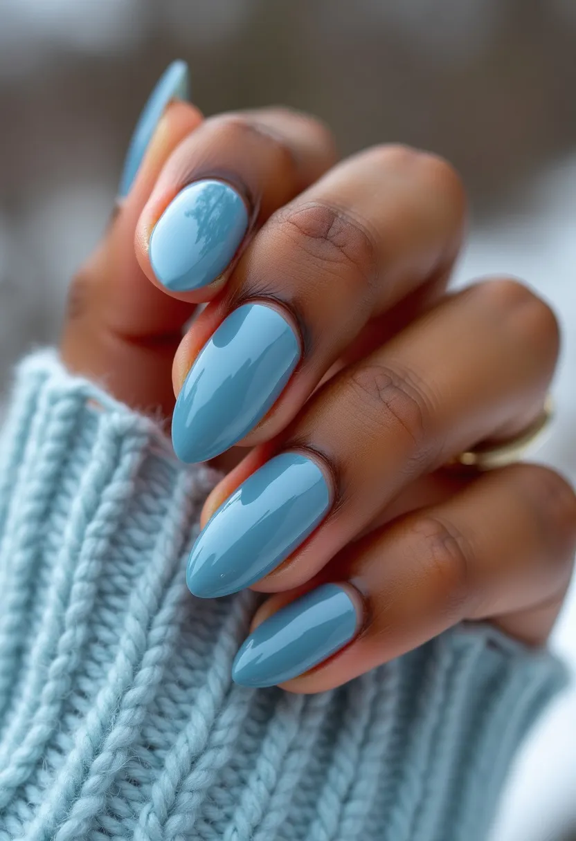 The nail design features a strikingly beautiful, solid light blue color palette that exudes a sense of calm and sophistication. The nails are shaped in an elegant almond form, which adds a touch of femininity and elongates the fingers gracefully. This nail design appears to use gel polish, as evidenced by the high-gloss finish and smooth texture, which highlights the polished, professional look of the treatment. There are no additional patterns or decorations, allowing the simplicity and elegance of the color and shape to stand out. This design could be seen as suitable for any season, but the serene light blue tone may particularly evoke a wintry theme, resonating with the cool, crisp ambiance of winter months. The overall look is refined and versatile, making it appropriate for both everyday wear and special occasions.